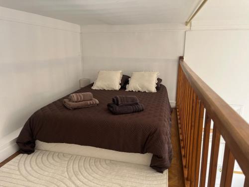 a bedroom with a bed with two towels on it at Le Cantilien Apartment - Chantilly in Chantilly
