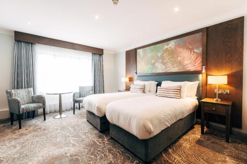 a hotel room with a large bed and a window at The Lodge Hotel in Coleraine