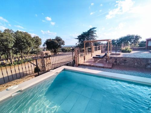 a swimming pool with a view of the water at VILLA CERRO MORENOVilla privada con piscina en finca exclusiva a 10 min de Lagunas de Ruidera in Ossa de Montiel