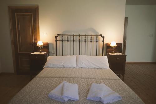 a bedroom with a bed with two towels on it at Casa Pousadoira in Miño