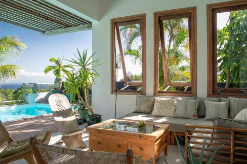 a living room with a couch and a table at Villa Bananes Rouges in Boyer