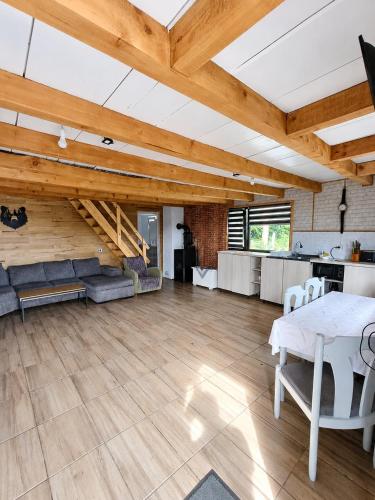 a large living room with wooden ceilings and a table at Cabana LoSt Ventoc in Vulcan
