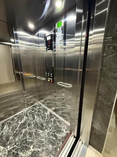 a metal shower with a marble floor in a room at Denizli - Akcakoca Suite in Zeytinkoy