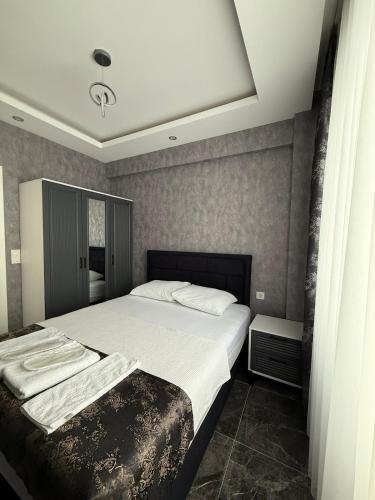 a bedroom with a large bed with white sheets at Denizli - Akcakoca Suite in Zeytinkoy
