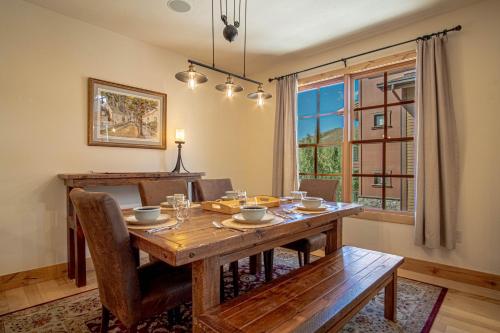 a dining room with a wooden table and a window at Elkhorn View Retreat in Sun Valley