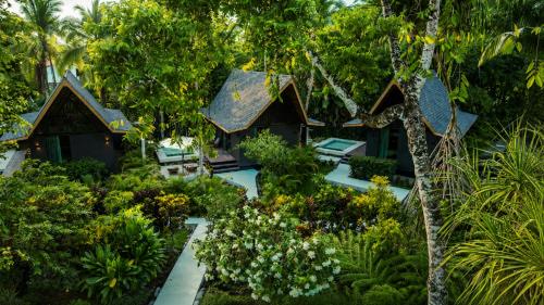 an aerial view of a resort with trees and plants at Namu Garden Hotel & Spa - Adults Only in Puerto Viejo