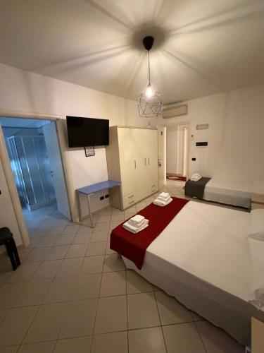 a bedroom with a large bed with a red blanket at M&M Rooms in Pannocchia