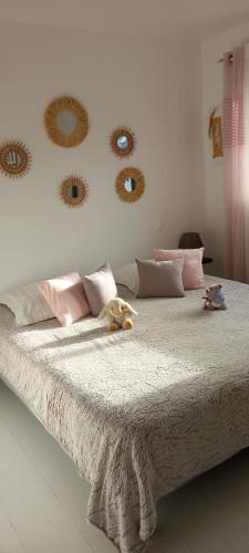 a bedroom with a large bed with mirrors on the wall at Chambres D'Hotes Chez Sylvie in Cancale