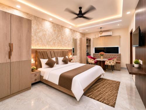 a bedroom with a bed and a living room at Aaditri Inn in Gorakhpur