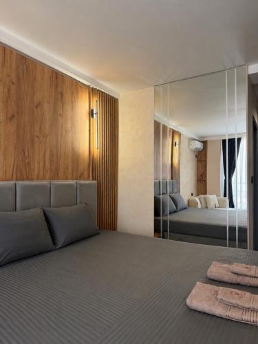 a bedroom with a large bed and a mirror at Hotel and Coffee Bar Old Bazaar in Skopje