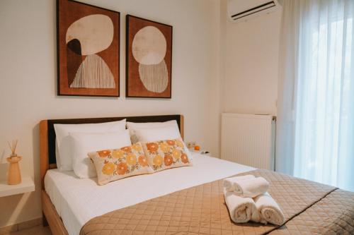 a bedroom with a bed with two towels on it at Tina's Resident in Igoumenitsa