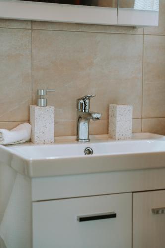 a bathroom sink with a faucet on top of it at Tina's Resident in Igoumenitsa
