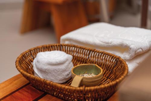 a basket with towels and a soap and a mirror at Vila Galé Collection Sunset Cumbuco in Cumbuco