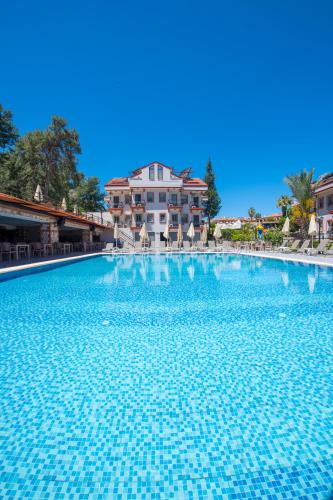 a large swimming pool in front of a building at Casa De Levıssı Ölüdeniz in Oludeniz