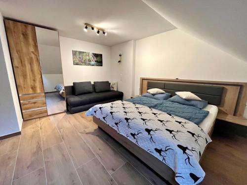 a bedroom with a bed and a chair at Forellenwirt Bacher in Kirchberg