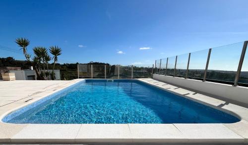 a swimming pool on the roof of a house at Villa Ericeira in Ericeira