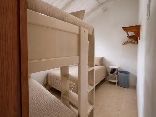 a bedroom with two bunk beds in a room at Hospedaje Isabela in Puerto Villamil