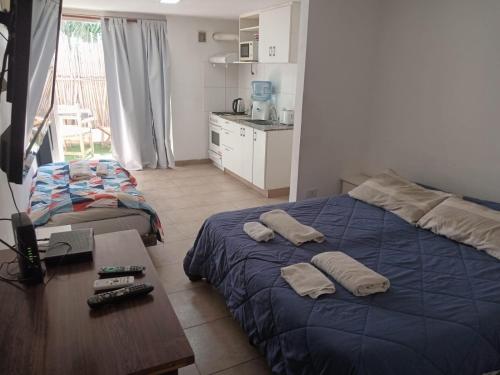 a bedroom with a blue bed with two pillows on it at Hotel Lincoln Rooms in Lincoln