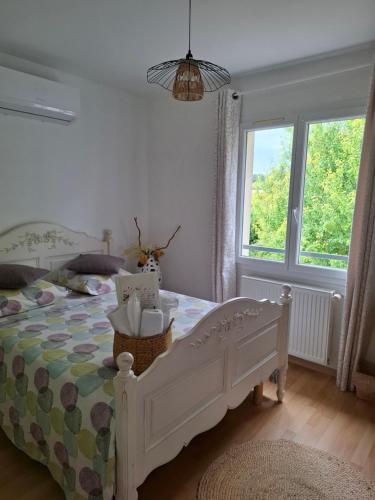 a bedroom with a bed and a window at Ker'mima in Antoigné Châtellerault in Châtellerault