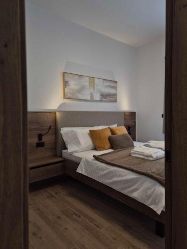 a bedroom with a bed with two pillows on it at Villa Freska in Rogaška Slatina