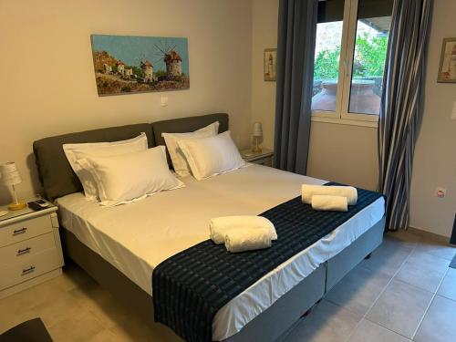 a bedroom with a bed with two towels on it at Lemnos Nest in Kondiás