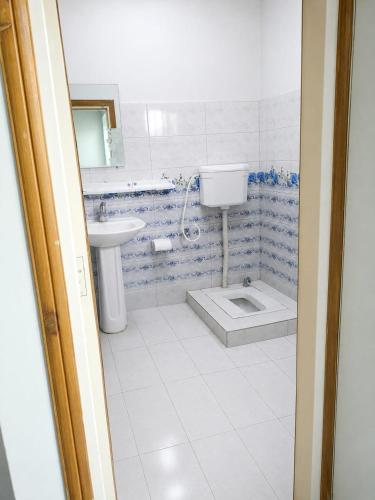 a bathroom with a sink and a toilet at Spacious 2 Bed Room Home Attached Baths, Lounge & Kitchen in Abbottabad