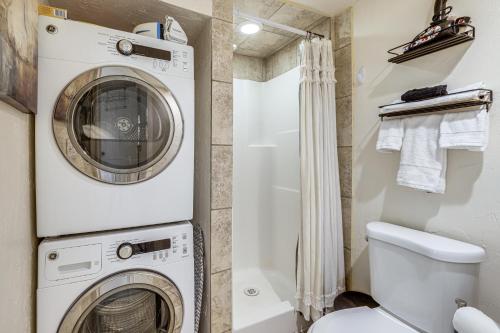 a bathroom with a washer and dryer next to a toilet at Work, Play & Explore w/ Ease! Dtwn Meridian Apt in Meridian