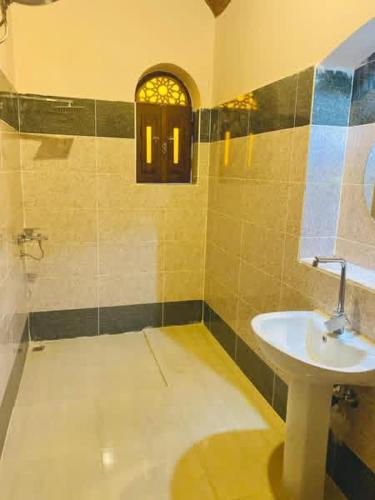 a bathroom with a sink and a window at Rahma House Hostel in Tunis