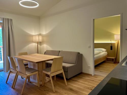 a room with a table and a couch and a bed at Haus der Achtsamkeit in Grünau im Almtal