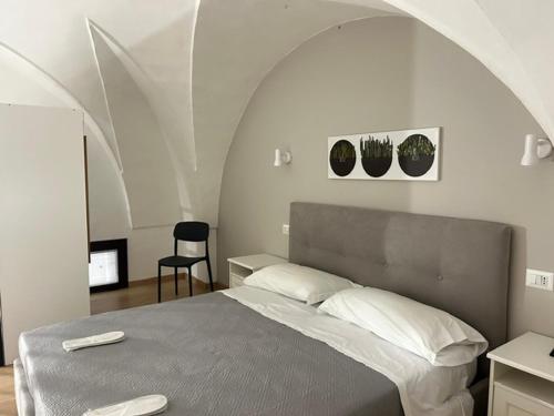 a bedroom with a bed with an arched ceiling at Largo Otranto - Guest House in Brindisi