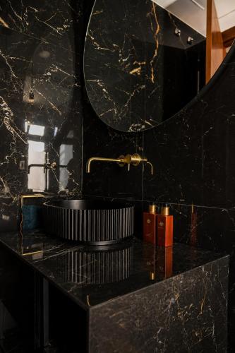 a black bathroom with a sink and a mirror at Villa de Anna in Adeje