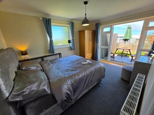 a bedroom with a bed and a view of a patio at Castle View Dover in Dover