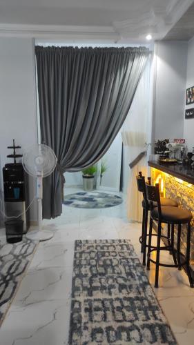 a living room with a fireplace and a table and chairs at Heaven 2 in Mīt Abū Shaykhah