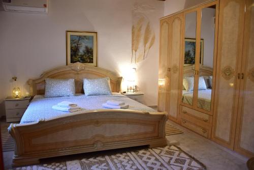 a bedroom with a wooden bed with towels on it at Lazatka in Samothraki