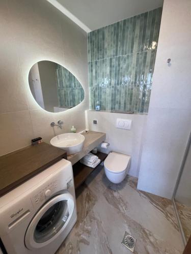 a bathroom with a washer and a washing machine in it at Villa Sakura in Lindos