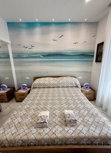 a bedroom with a bed with a painting on the wall at Capri House - camera Luna Caprese in Minori