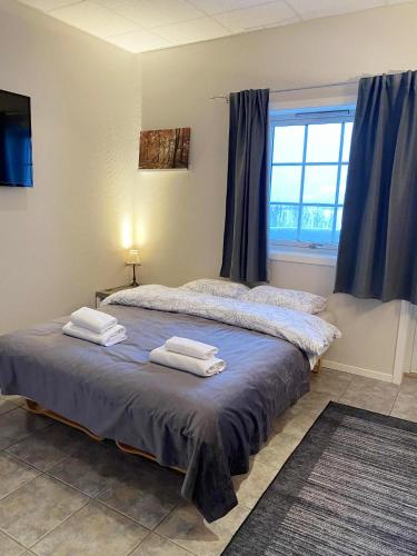 a bedroom with two beds with towels on them at Svenningdal Camping in Svenningdal
