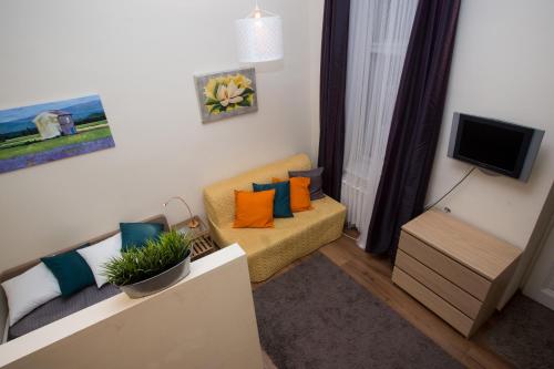 a living room with a couch and a tv at Home Apartment near Blaha Lujza Square in Budapest