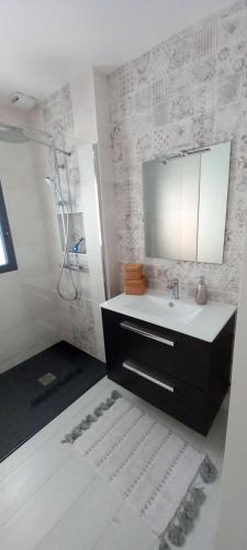 a bathroom with a sink and a mirror at Chambres D'Hotes Chez Sylvie in Cancale