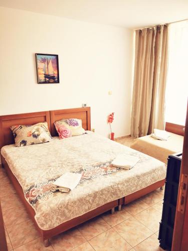 a bedroom with a large bed and a window at Apartment Blue Komfort in Sunny Beach