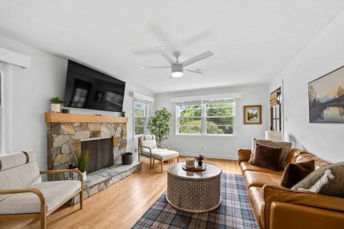 a living room with a couch and a fireplace at Black Mountain Bungalow Steps to Town Backyard in Black Mountain