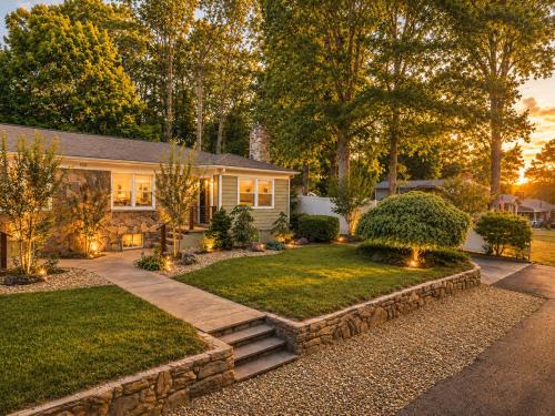 a home with a yard with a stone pathway at Black Mountain Bungalow Steps to Town Backyard in Black Mountain