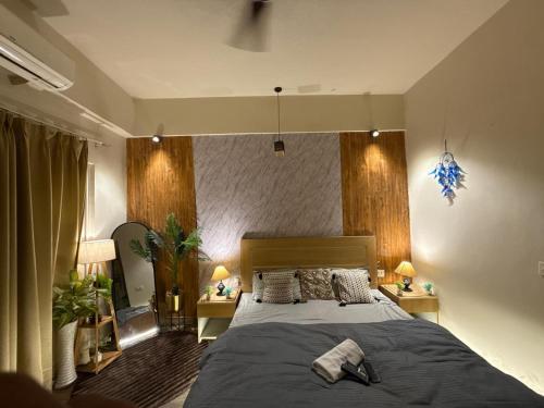 a bedroom with a large bed and two night stands at Nest And Rest Stay in Greater Noida