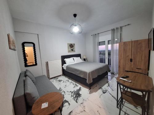 a bedroom with a bed and a couch and a table at Imeros Summer Home 3 in Ímeros
