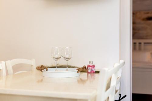 two wine glasses sitting on top of a table at Apartment Magnolia in Šilo