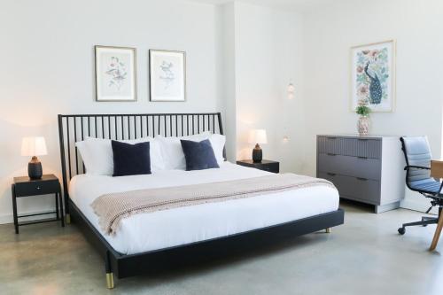 a bedroom with a black and white bed and a chair at Modern Studio by Brickell & Beach in Miami
