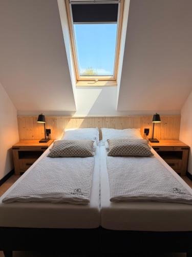 three beds in a room with a window at 4Sosny, jacuzzi, siłownia, sauna, widok na Śnieżkę in Miłków