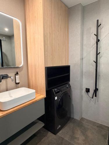 a bathroom with a washing machine and a sink at 4Sosny, jacuzzi, siłownia, sauna, widok na Śnieżkę in Miłków