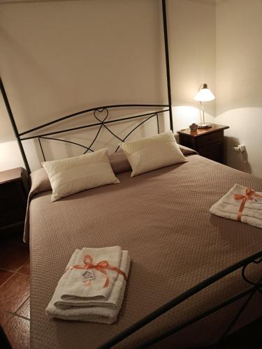 a bedroom with a bed with towels on it at Villa Rosa in Andria