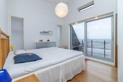 a bedroom with a large bed and a large window at VGO1063-Karlsborg-Silverdalen-1 in Karlsborg